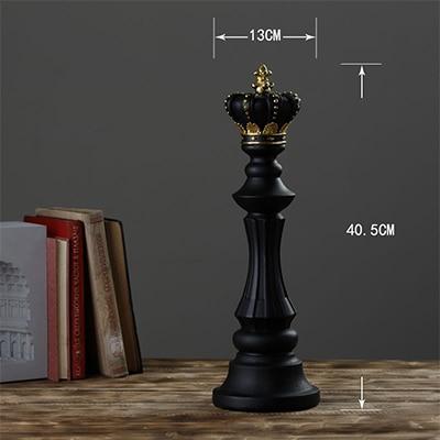 Black decorative chess queen on wooden table